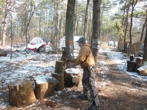 Tent City Angelo chopping wood to heat his home(tent)
